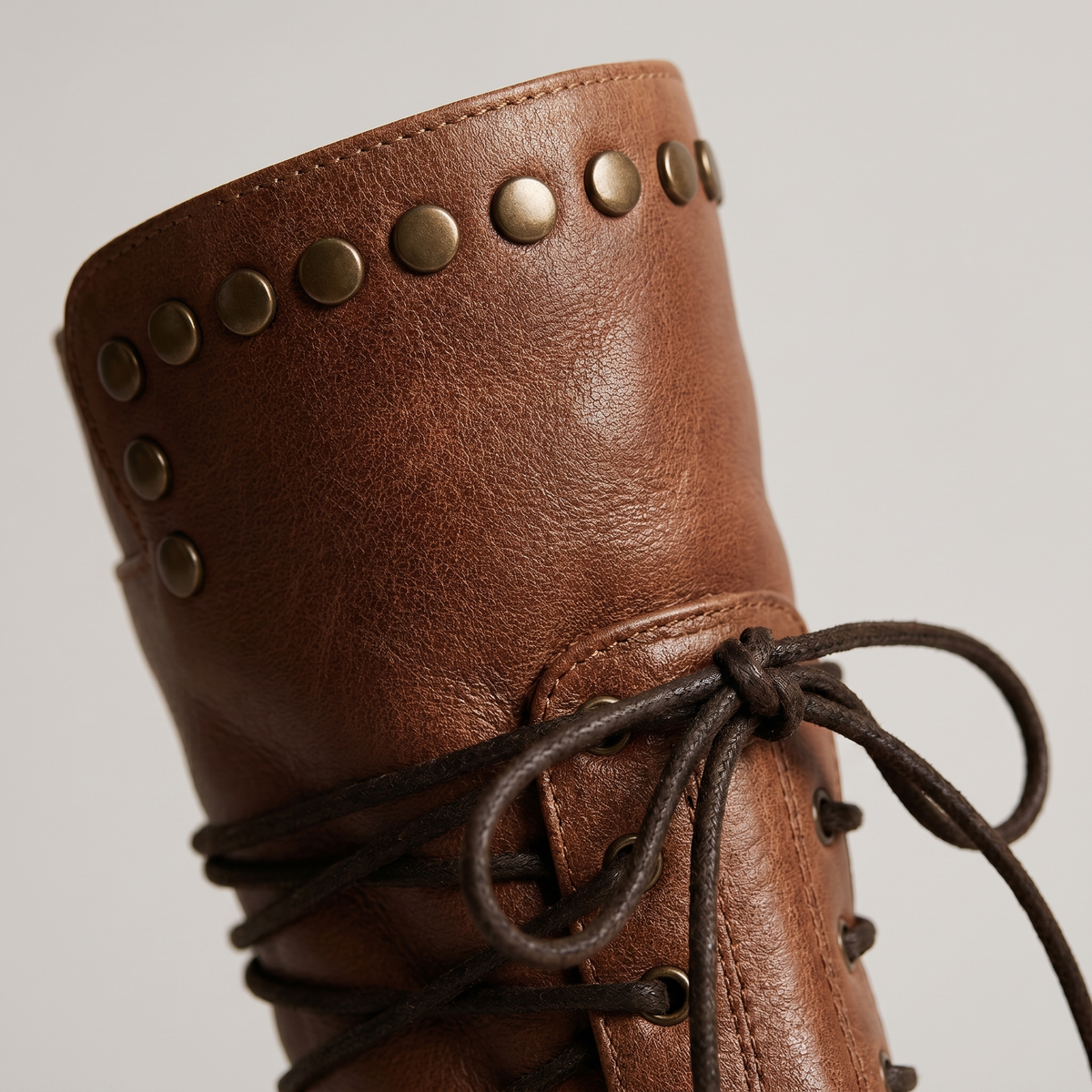 Women's lace-up mid-calf boots with studded cuffs and low block heels