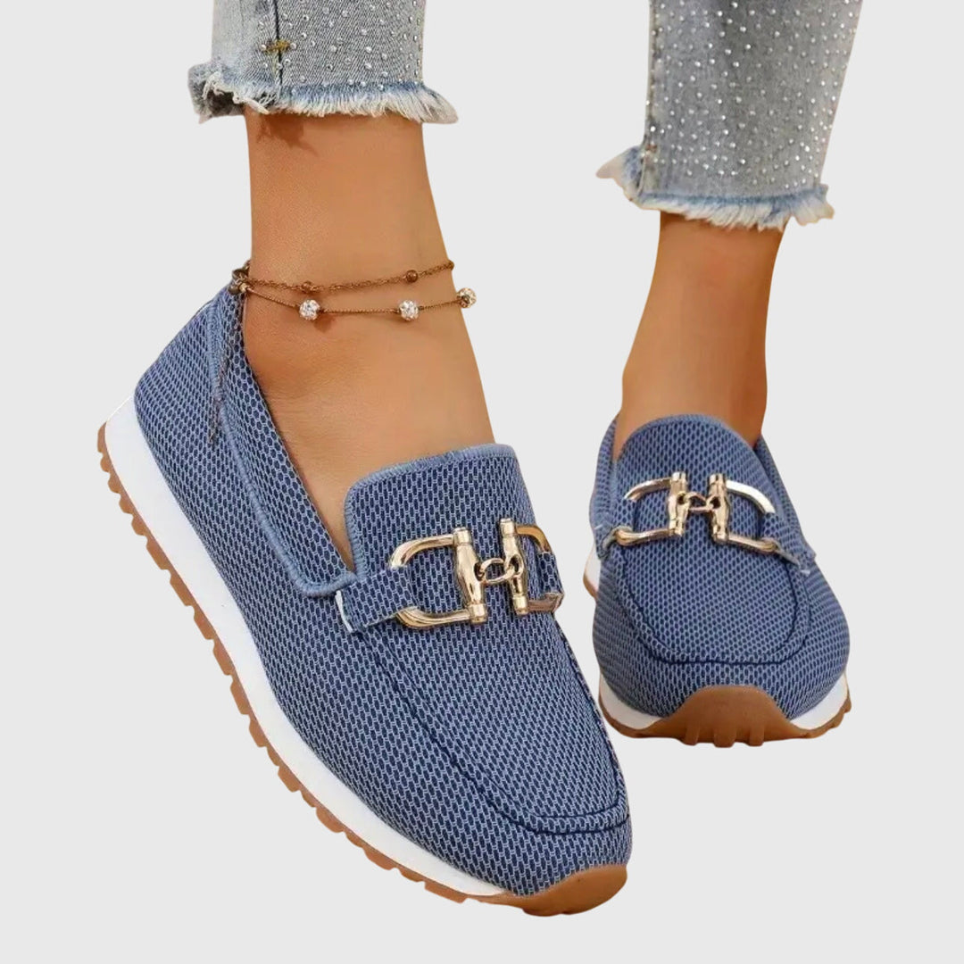 Women's textured slip-on loafers with decorative buckle detail and ridged soles