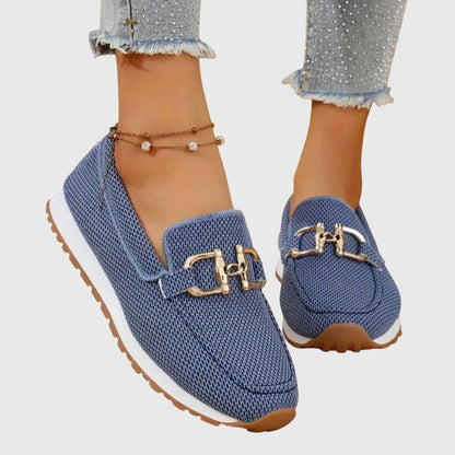 Women's textured slip-on loafers with decorative buckle detail and ridged soles