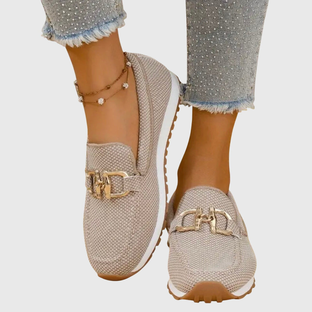 Women's textured slip-on loafers with decorative buckle detail and ridged soles