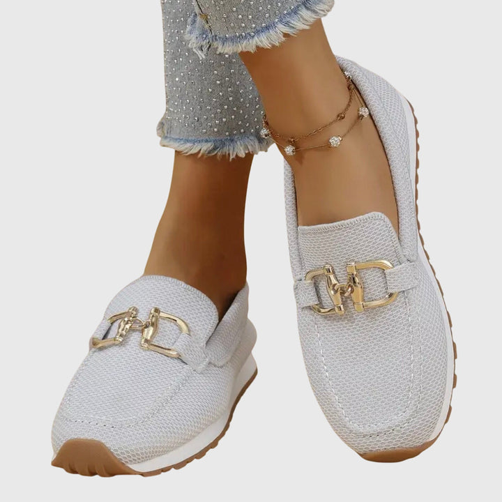 Women's textured slip-on loafers with decorative buckle detail and ridged soles