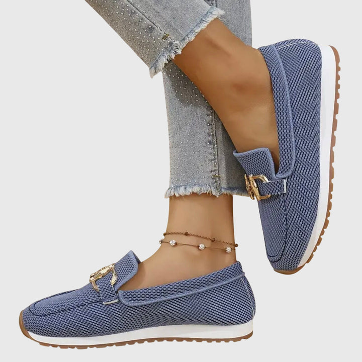 Women's textured slip-on loafers with decorative buckle detail and ridged soles