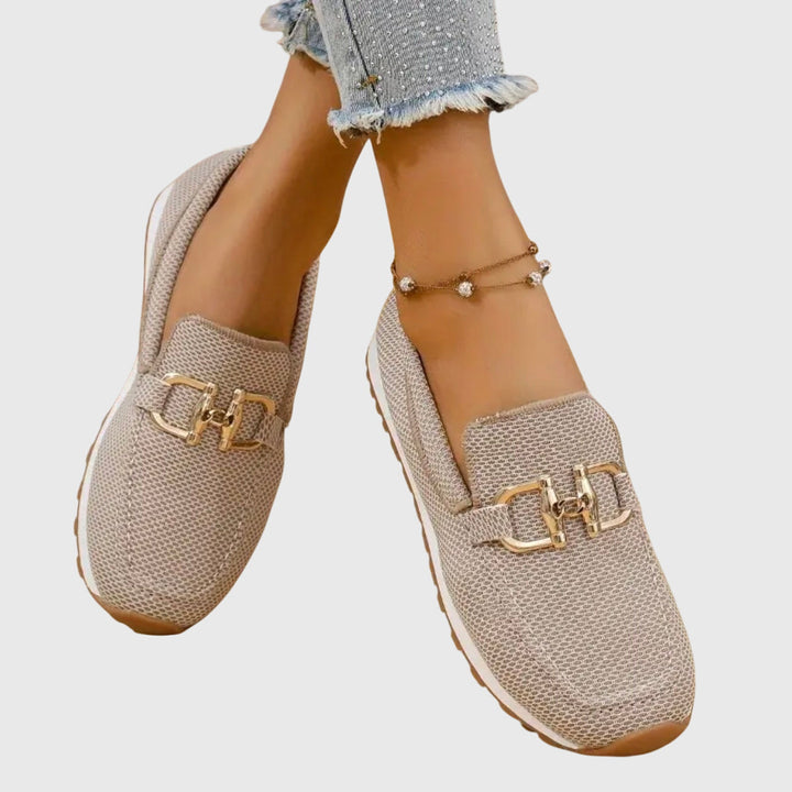 Women's textured slip-on loafers with decorative buckle detail and ridged soles