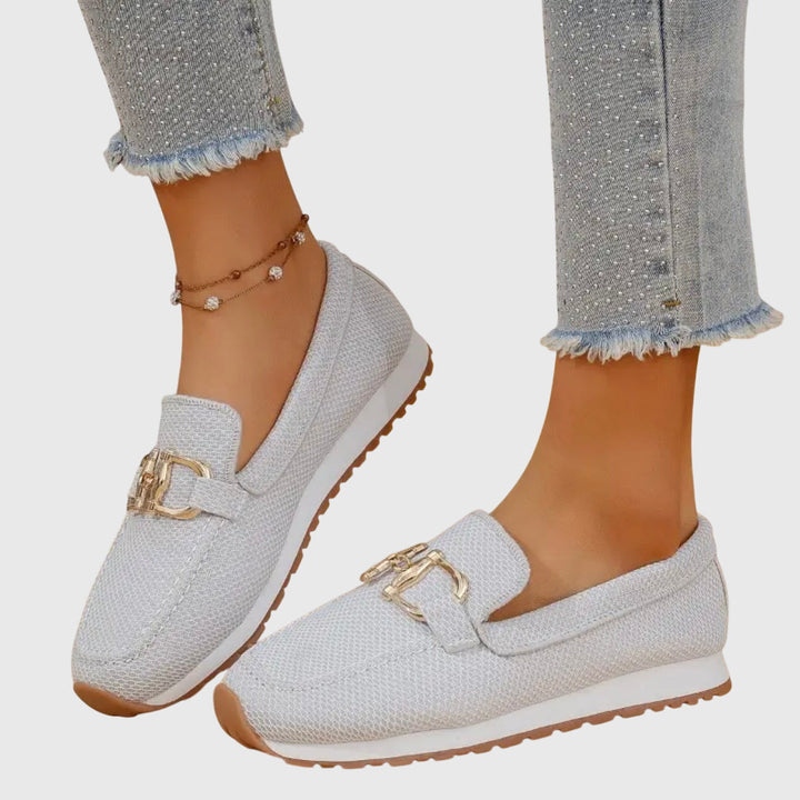 Women's textured slip-on loafers with decorative buckle detail and ridged soles