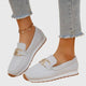 Women's textured slip-on loafers with decorative buckle detail and ridged soles