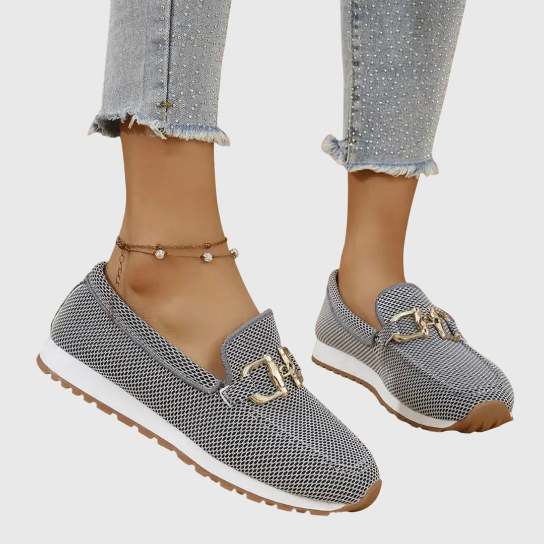 Women's textured slip-on loafers with decorative buckle detail and ridged soles