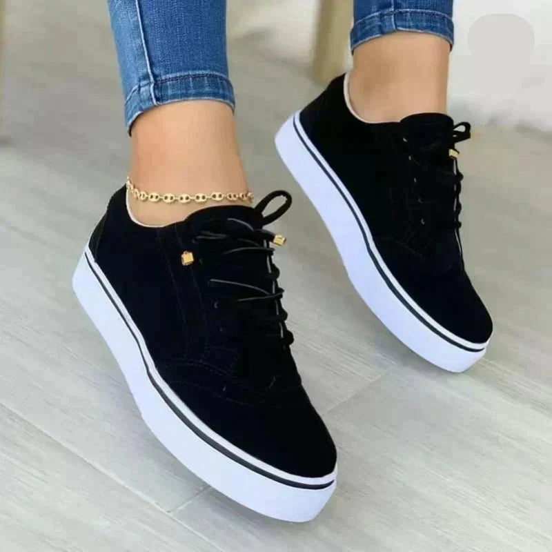Women's low-top lace-up sneakers with brogue-style perforated detailing and thick platform soles