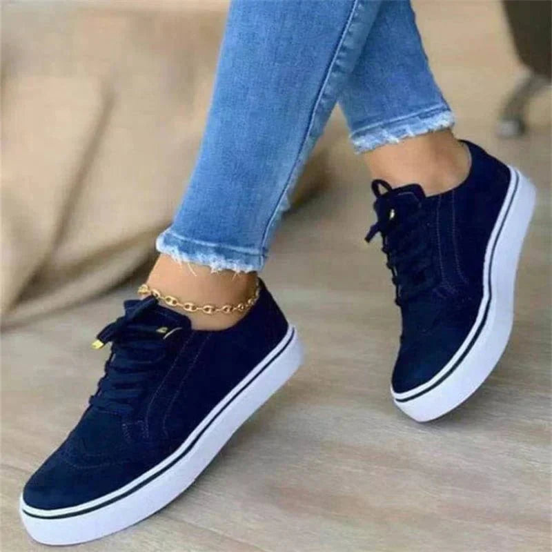 Women's low-top lace-up sneakers with brogue-style perforated detailing and thick platform soles