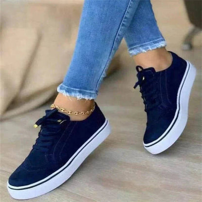 Women's low-top lace-up sneakers with brogue-style perforated detailing and thick platform soles