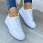 Women's low-top lace-up sneakers with brogue-style perforated detailing and thick platform soles