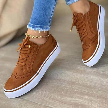 Women's low-top lace-up sneakers with brogue-style perforated detailing and thick platform soles