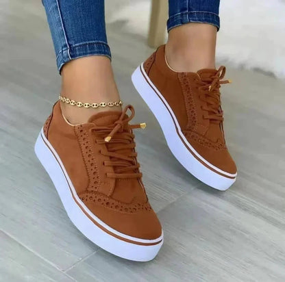 Women's low-top lace-up sneakers with brogue-style perforated detailing and thick platform soles