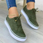 Women's low-top lace-up sneakers with brogue-style perforated detailing and thick platform soles