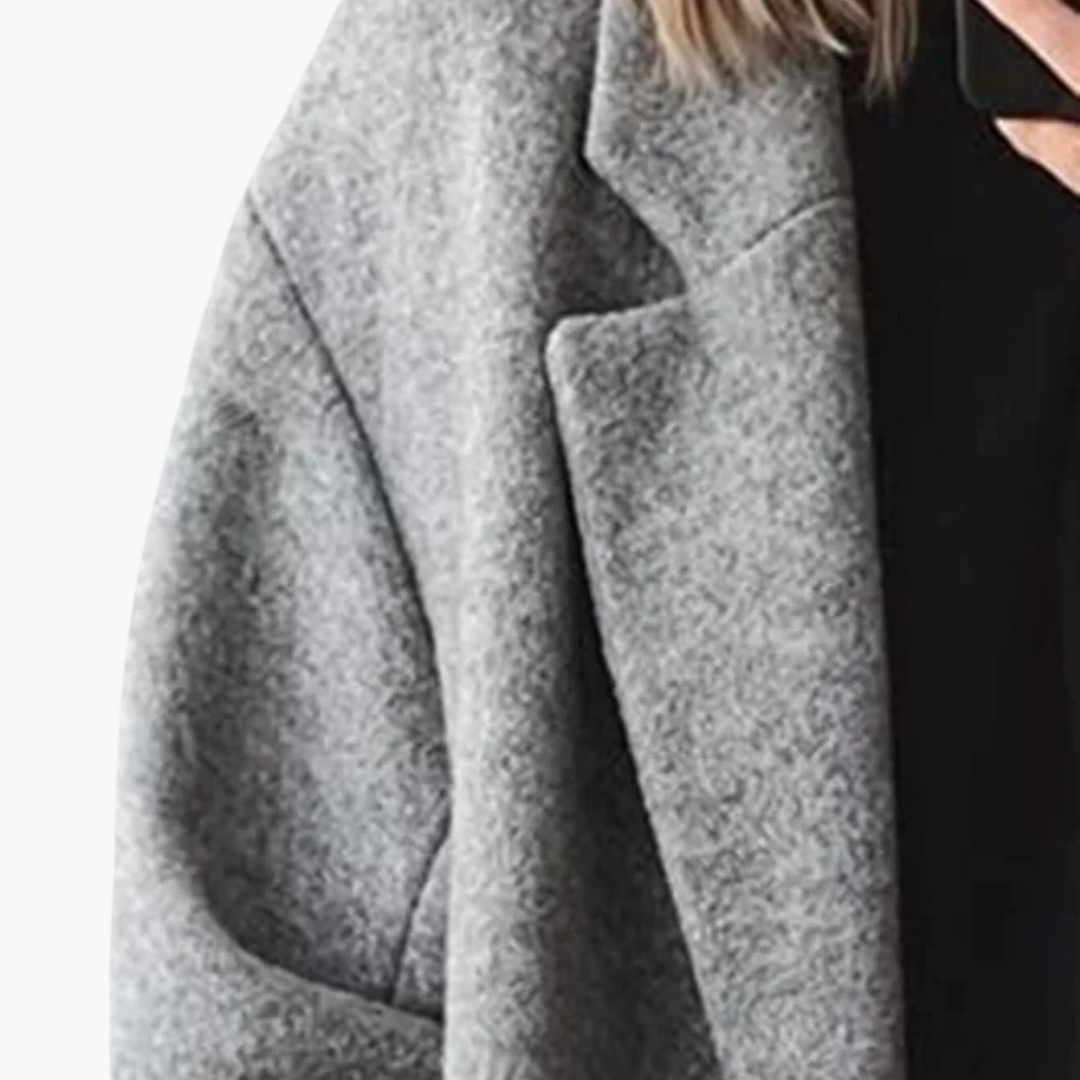 Women's longline collared coat with wide lapels, long sleeves and button details