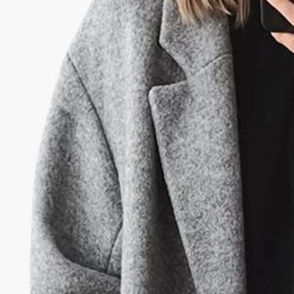 Women's longline collared coat with wide lapels, long sleeves and button details