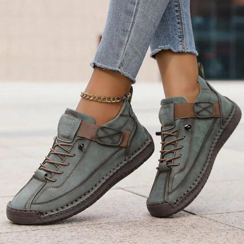 Women's casual lace-up sneaker with stitched panels and side strap