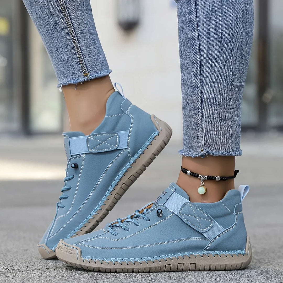 Women's casual lace-up sneaker with stitched panels and side strap