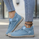 Women's casual lace-up sneaker with stitched panels and side strap