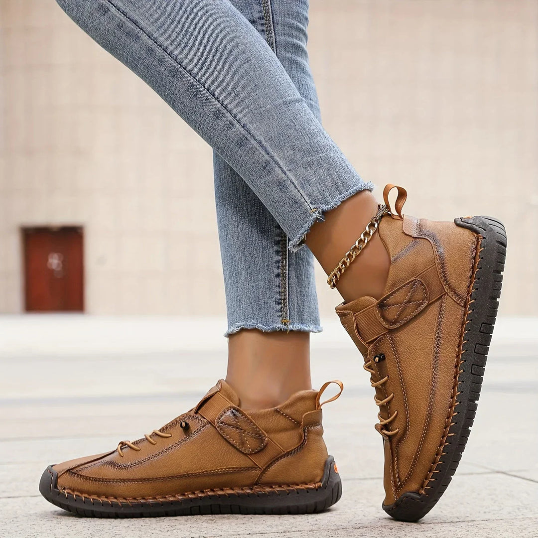 Women's casual lace-up sneaker with stitched panels and side strap